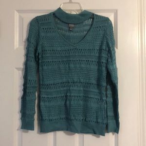 Blue V-neck sweater with neck strap .